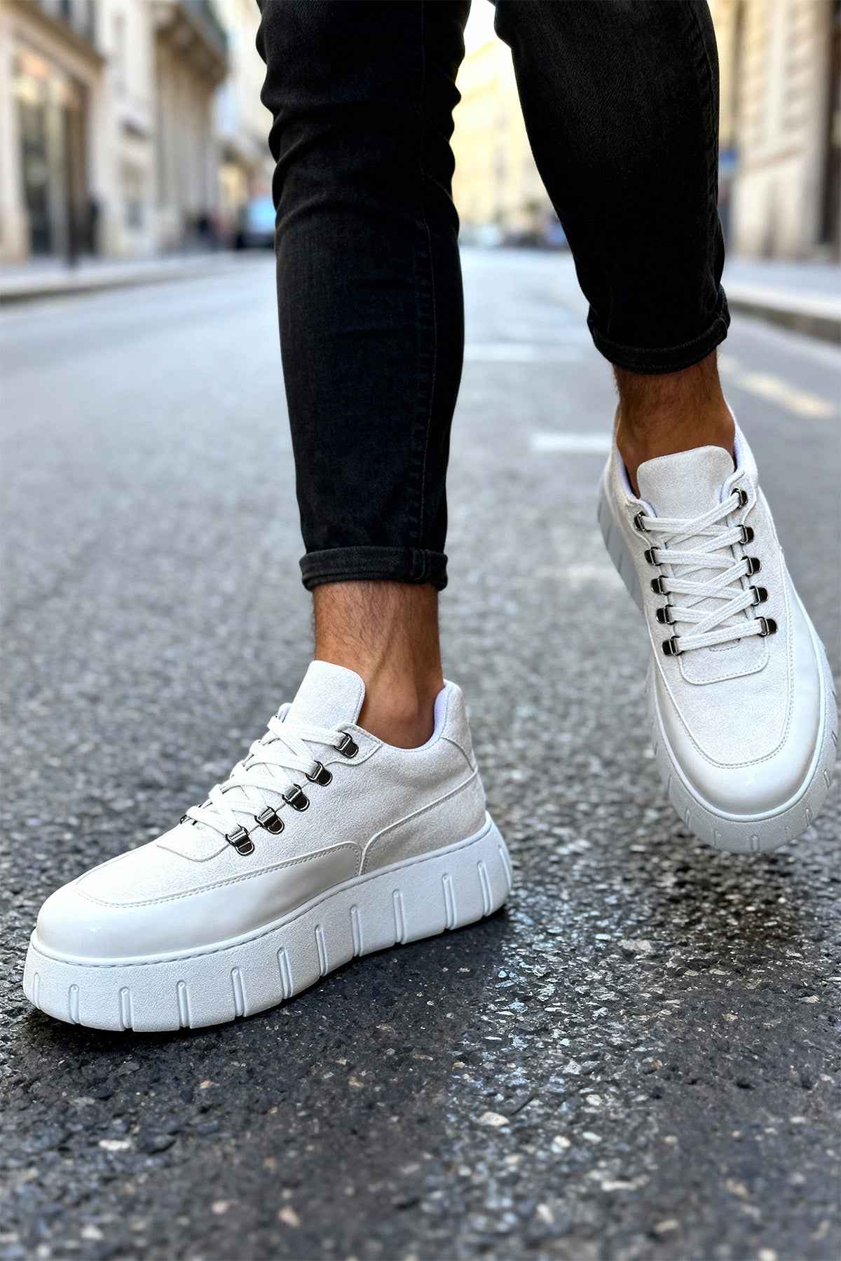 White suede lace-up sneakers with thick textured sole, front side view.